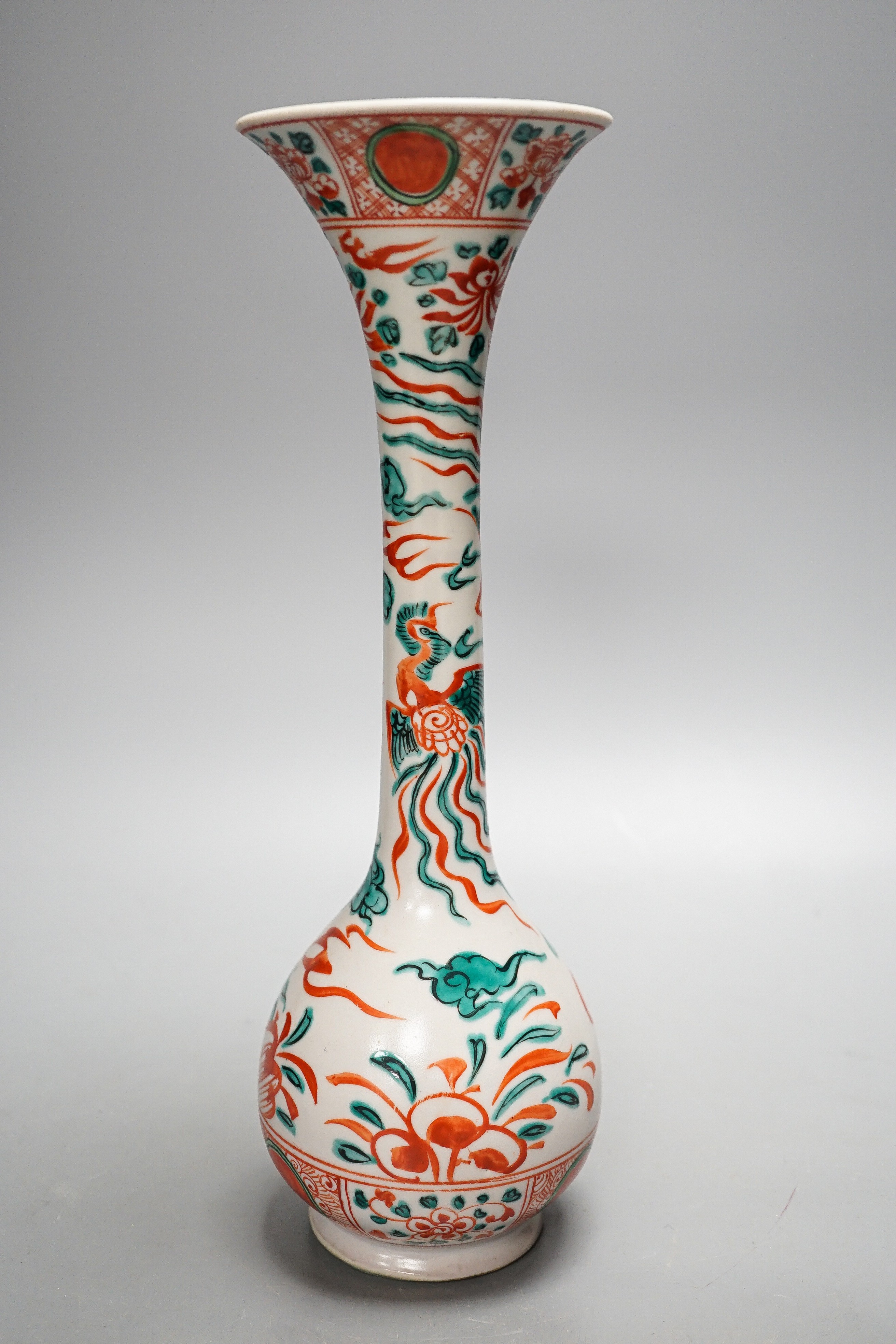 A Chinese Swatow style bottle vase, painted in green and iron red enamels with phoenixes amid flowers and clouds, 31.5cm